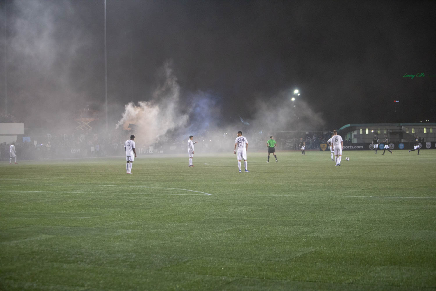 Smoke hovers over the soccer field
