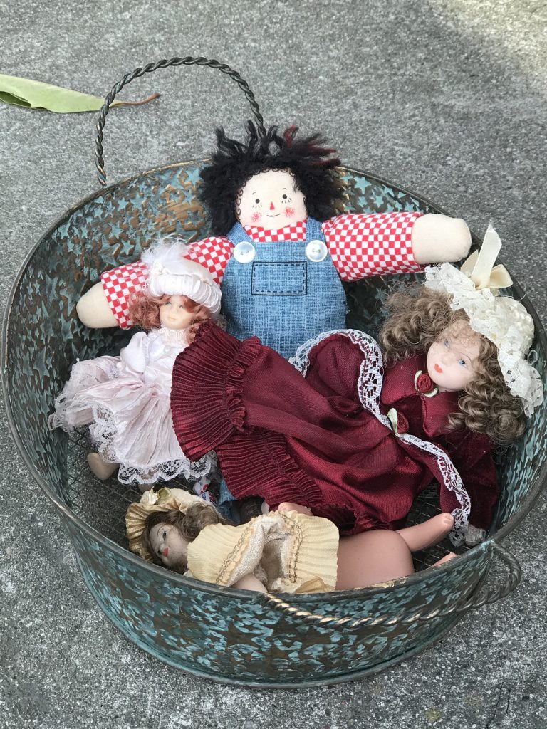 A bucket of dolls found on a downtown sidewalk. We are all in this together. Berkeley, California. Wednesday, April 8th, 2020. Photo Pam Rudd.