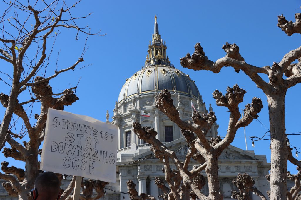 Sign reading Students 1st - Stop Downsizing CCSF on display at Civic Center Park in San Francisco, CA during the March 12, 2021 Defend Our City College demonstration. (Photo by Luke Wrin Piper/The Citizen)