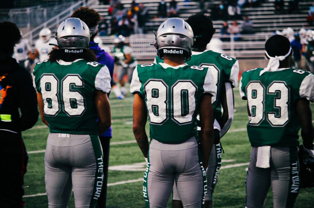 Laney football players waiting on the sideline. (Zach Thompson/The Citizen)
