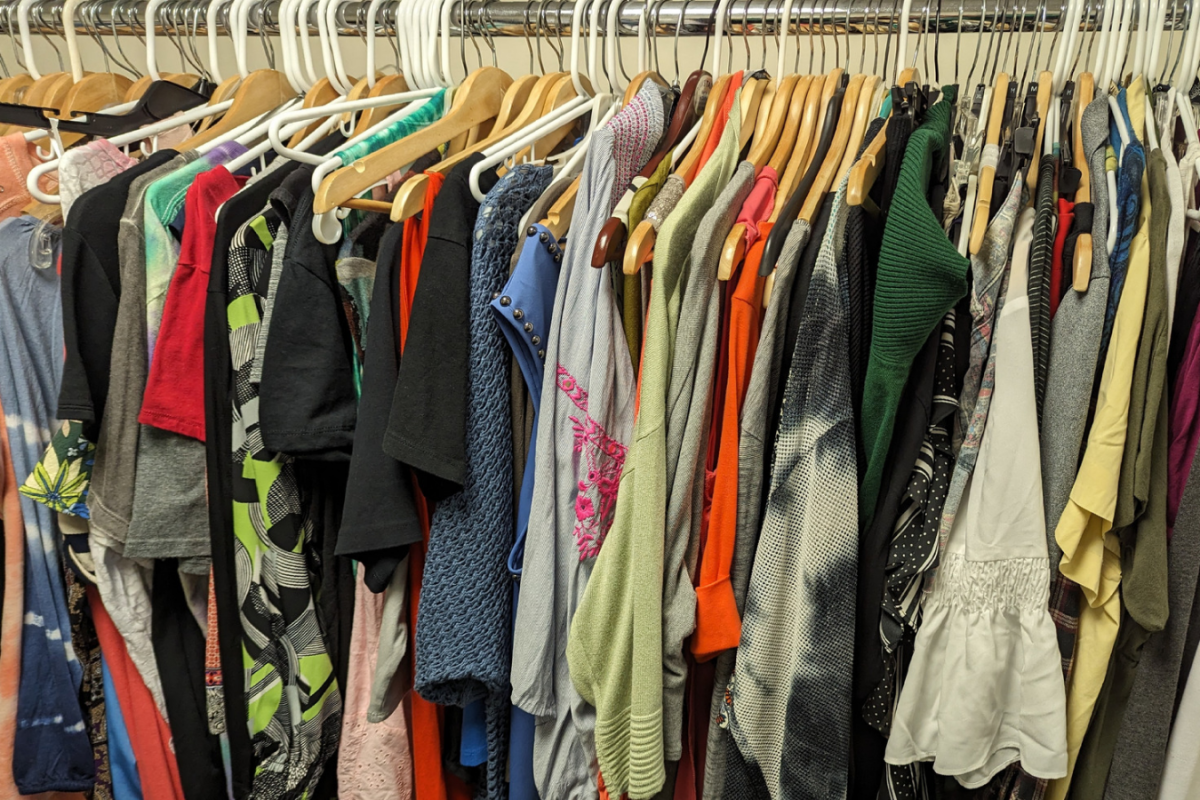 Secondhand clothes in a variety of sizes and styles sit on a rack in the newly opened clothing exchange, where PCCD students can now access free clothes and shoes. (Photo: Desmond Meagley)