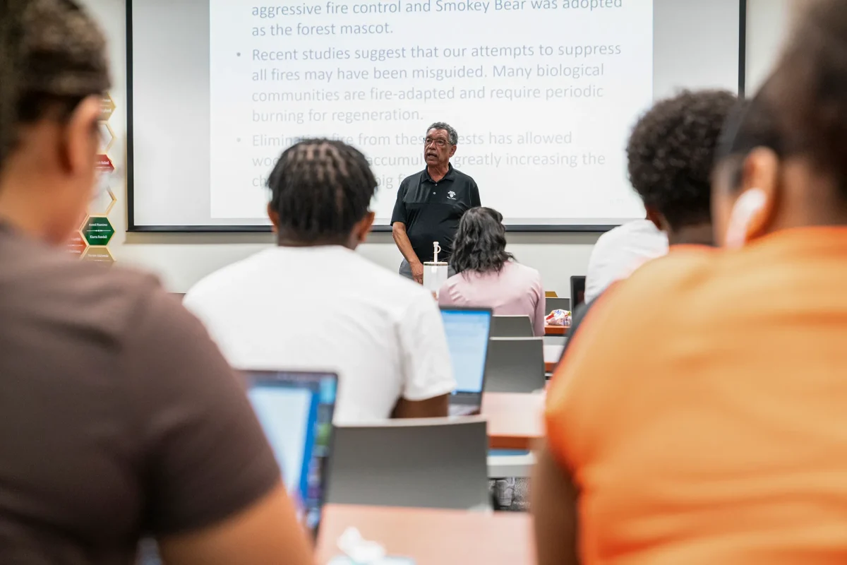 Professor Dr. James W. Reede Jr. lectures students on the environmental impacts of California policies in the seminar hall of the Black Honors College at Sacramento State University on Oct. 3, 2024. (Photo: Louis Bryant III/CalMatters)
