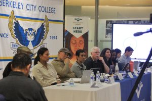 The Board of Trustees listens intently as public comments are under way.