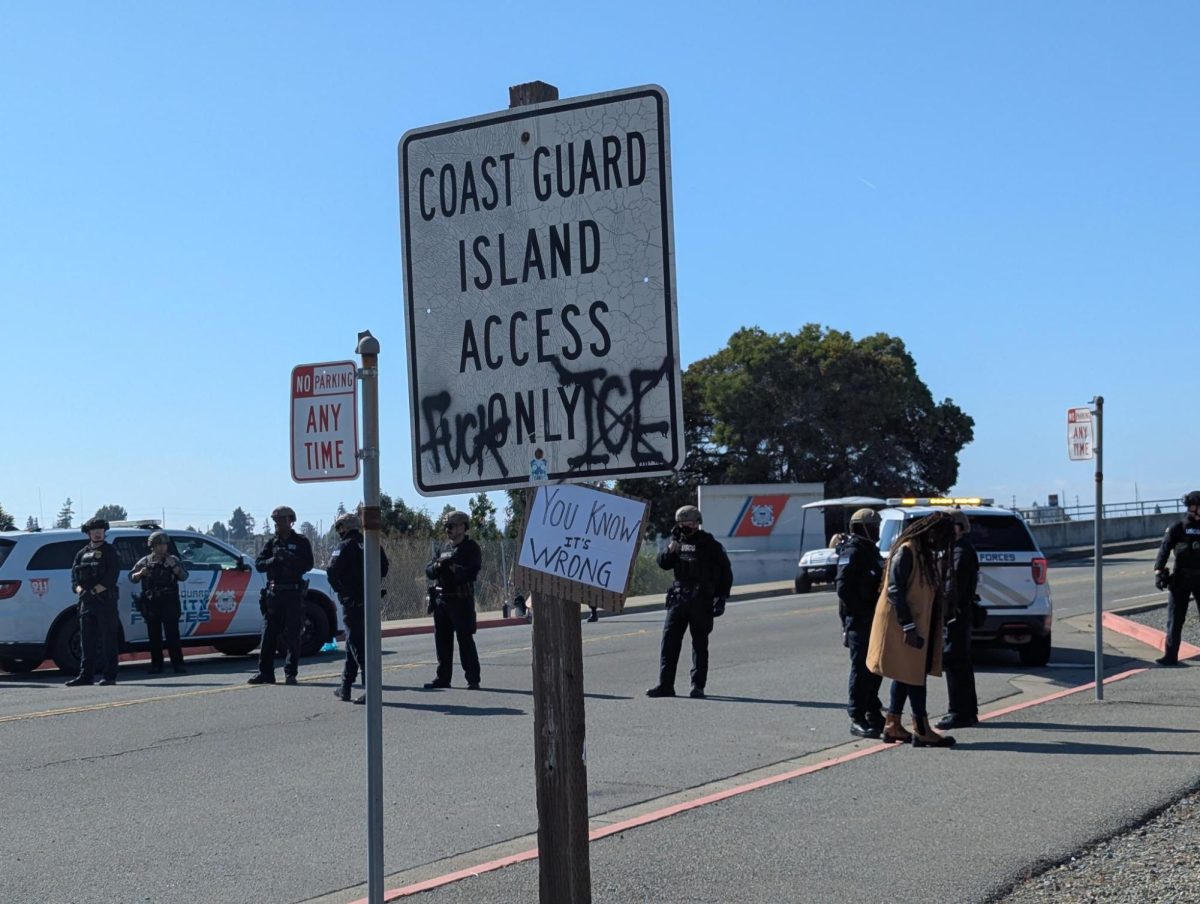A graffitied sign at the Oakland entrance of the Coast Guard Island near Alameda, CA on October 23, 2025.