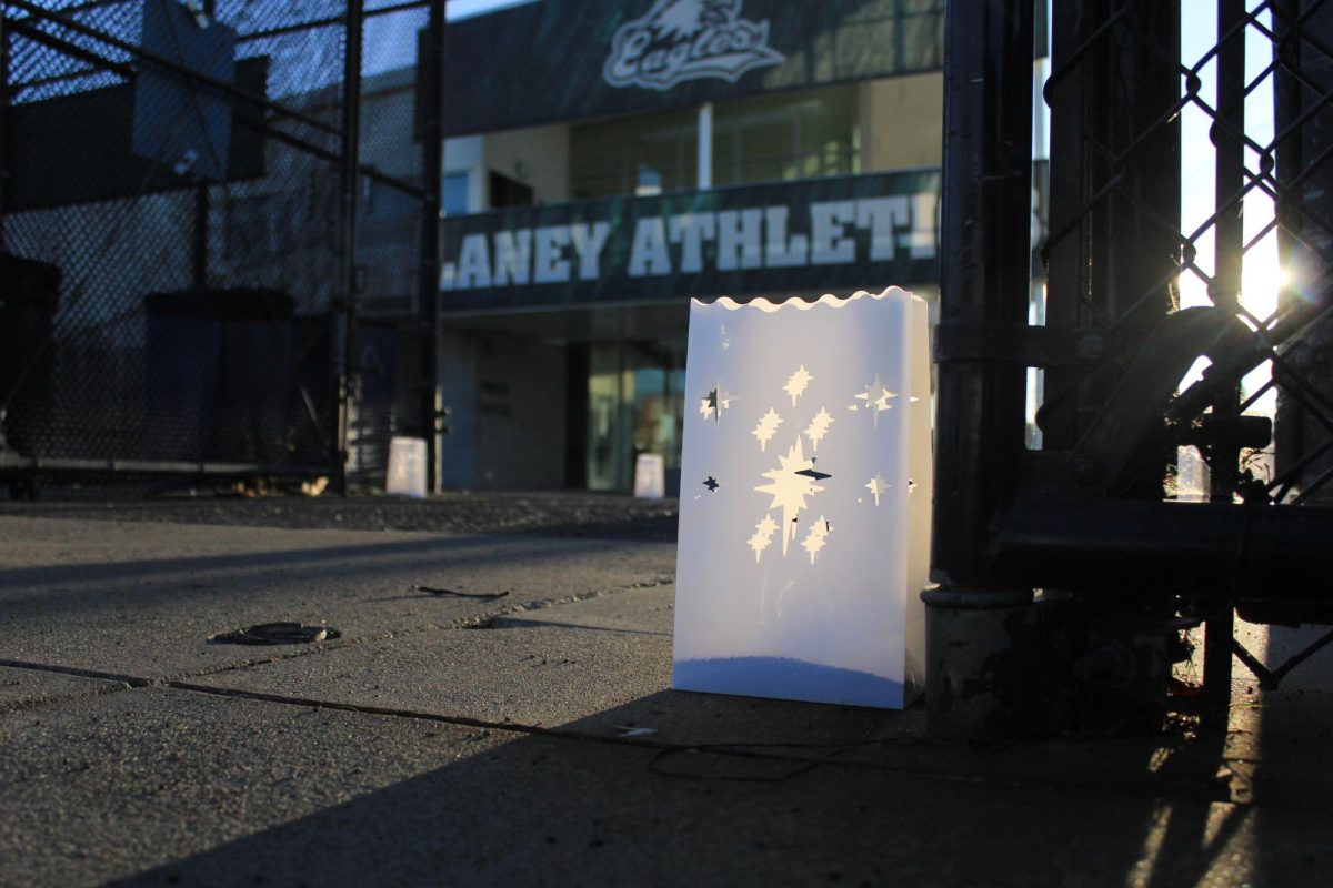 A white luminaria lantern sits in front of the Fieldhouse for the John Beam memorial walk at Laney College in Oakland, CA on Dec. 10, 2025. 