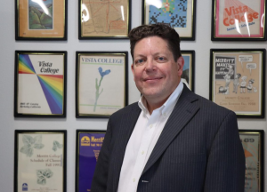 Mark Johnson stands in front of an archival display of promotional Peralta materials in Oakland, Calif. on April 23, 2026.